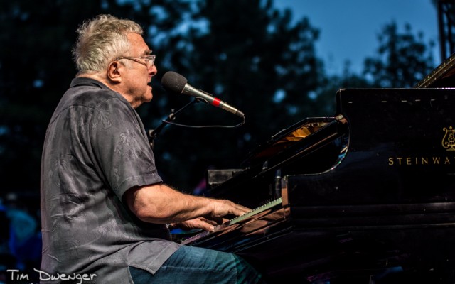 Randy Newman – August 7th – Denver Botanic Gardens There's no skirting the issue here, this was one of the wettest concerts of the year. While a good number of folks clearly stayed home, about two-thirds of the ticket holders showed up and took their spots on the Botanic Gardens lawn for a night with the incomparable songwriter Randy Newman. After being shuttled to the stage in a golf cart, Newman started his set shortly after 6:30 as fans tried to keep their cheese and crackers out of the incessant rain which didn't let up until the musician said "good-night."